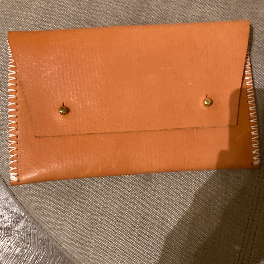 Leather clutch with blue holder on back NWOT